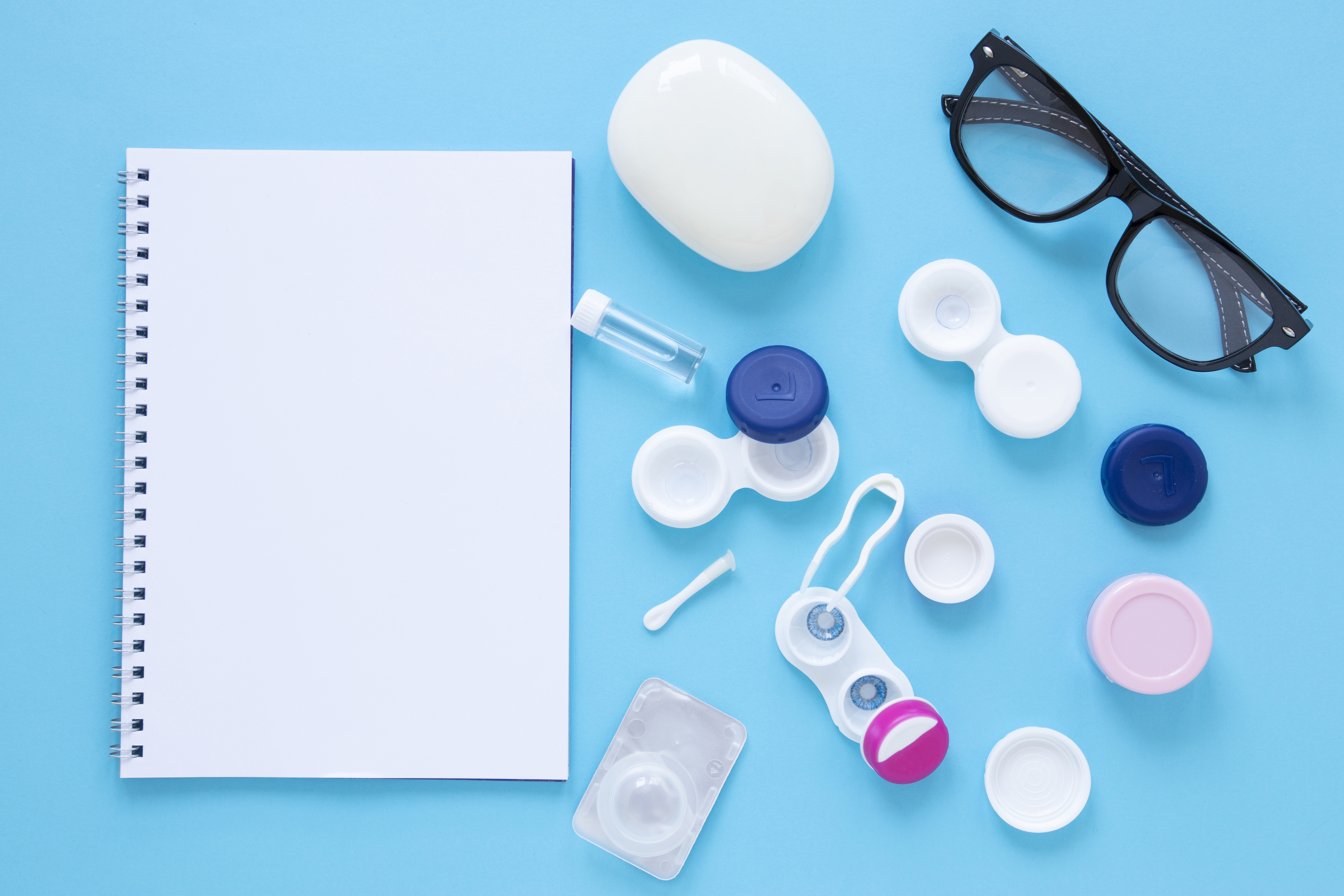 eye-care-products-blue-background-with-notebook-mock-up